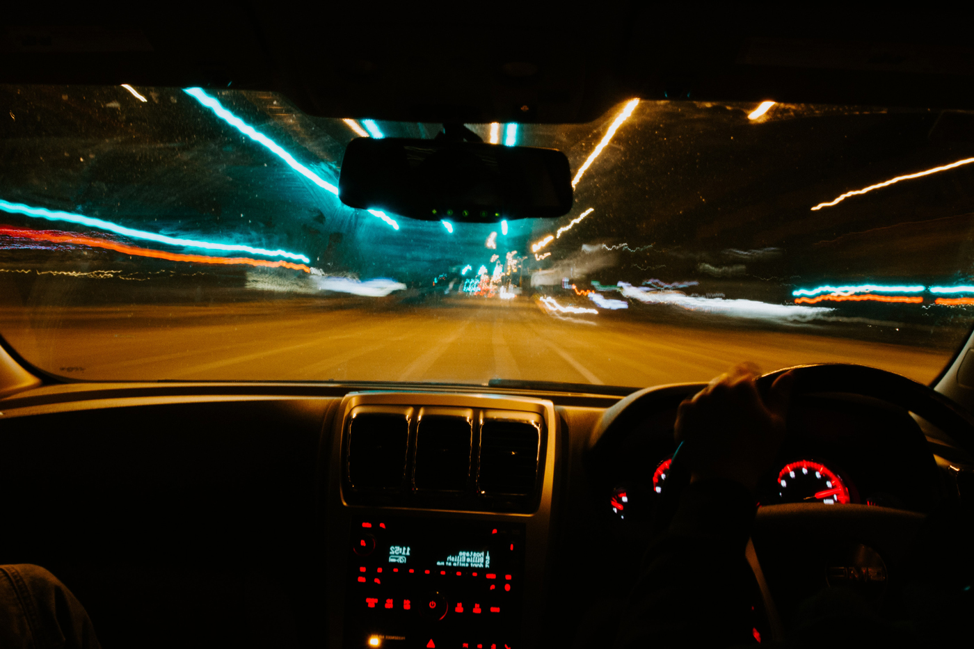 A drivers perspective of driving under the influence with blurred lights at the road side