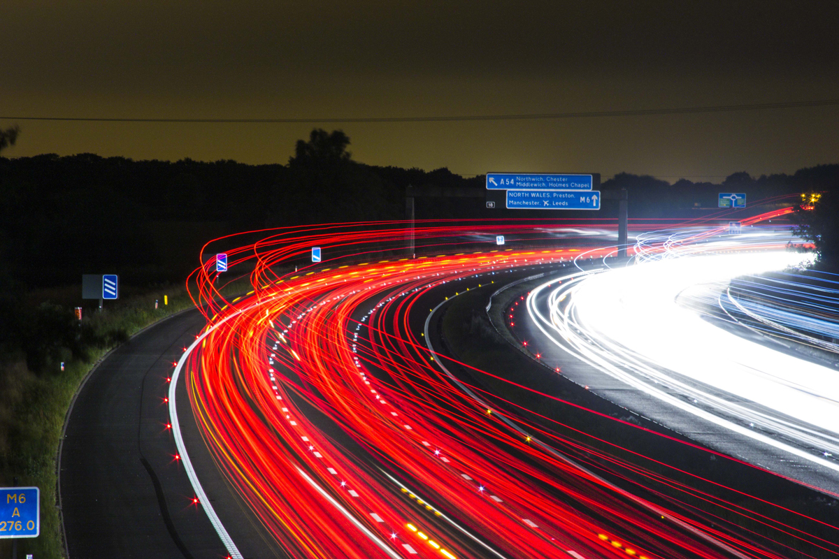A time-lapse of a busy motorway bend at night