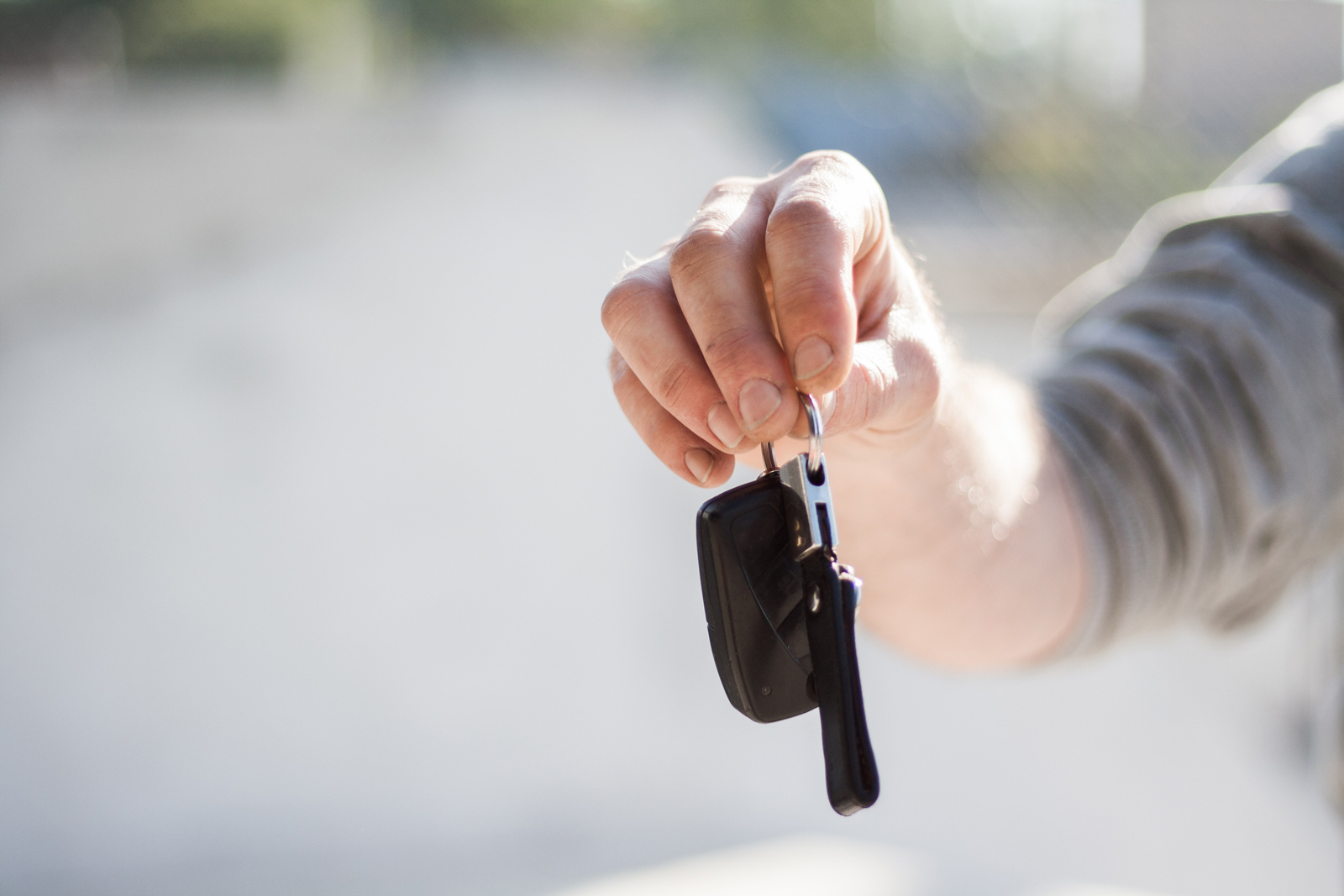 A person handing keys to a new driver