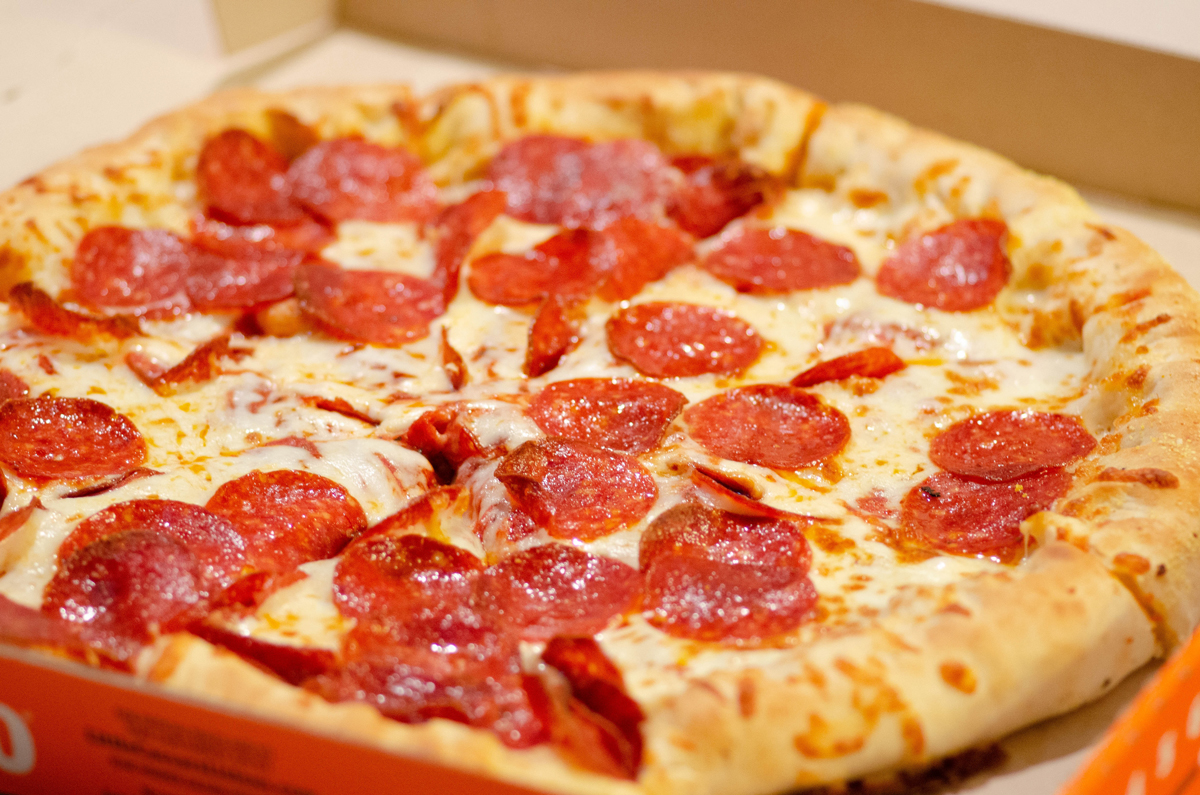 A pepperoni pizza in a takeaway box